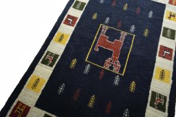 Backside of handmade New Persian Gabbeh rug showing knot structure and weave density