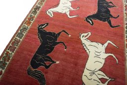 Backside of handmade 2000s Persian Gabbeh rug showing knot structure and weave density