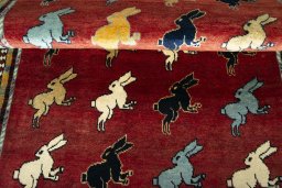 Full view of 2000s Persian Gabbeh rug from Iran / Persia, 175 × 102 cm in Red tones