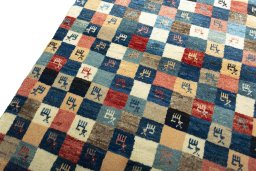 Backside of handmade 2000s Persian Gabbeh rug showing knot structure and weave density