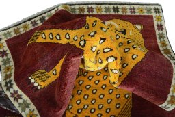 Corner detail of 2000s Persian Gabbeh rug showing border pattern and Wool pile
