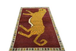 Surface texture of 2000s Persian Gabbeh rug with natural Wool and intricate pattern