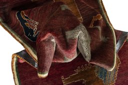 Corner detail of 2000s Persian Gabbeh rug showing border pattern and Wool pile