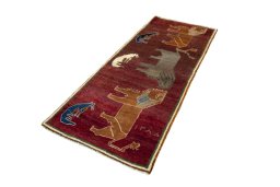 Corner detail of 2000s Persian Gabbeh rug showing border pattern and Wool pile