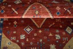 Corner detail of 2000s Persian Gabbeh rug showing border pattern and Wool pile