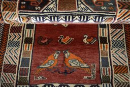 Corner detail of 2000s Persian Gabbeh rug showing border pattern and Wool pile