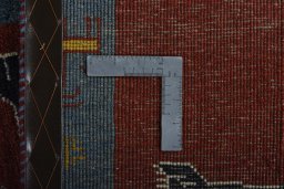 Corner detail of 2000s Persian Gabbeh rug showing border pattern and Wool pile