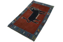 Corner detail of 2000s Persian Gabbeh rug showing border pattern and Wool pile