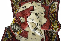 Corner detail of 2000s Persian Gabbeh rug showing border pattern and Wool pile