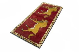 Corner detail of 2000s Persian Gabbeh rug showing border pattern and Wool pile