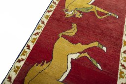 Backside of handmade 2000s Persian Gabbeh rug showing knot structure and weave density