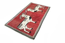Corner detail of 2000s Persian Gabbeh rug showing border pattern and Wool pile