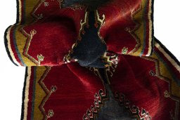 Corner detail of 2000s Persian Gabbeh rug showing border pattern and Wool pile