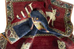 Corner detail of 2000s Persian Gabbeh rug showing border pattern and Wool pile