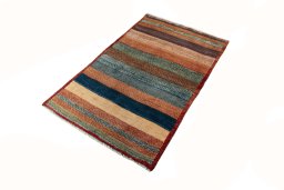 Corner detail of 2000s Persian Gabbeh rug showing border pattern and Wool pile
