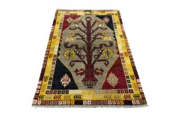 Surface texture of 2000s Persian Gabbeh rug with natural Wool and intricate pattern