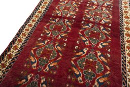 Backside of handmade 2000s Persian Gabbeh rug showing knot structure and weave density