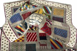 Corner detail of 2000s Persian Gabbeh rug showing border pattern and Wool pile