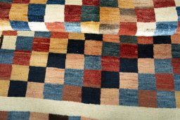 Full view of 2000s Persian Gabbeh rug from Iran / Persia, 185 × 150 cm in Multi Color tones