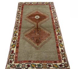 Surface texture of 2000s Persian Gabbeh rug with natural Wool and intricate pattern
