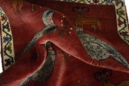 Corner detail of 2000s Persian Gabbeh rug showing border pattern and Wool pile