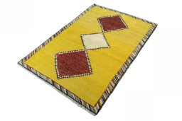 Corner detail of 2000s Persian Gabbeh rug showing border pattern and Wool pile