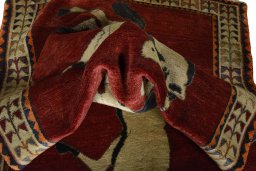 Corner detail of 2000s Persian Gabbeh rug showing border pattern and Wool pile