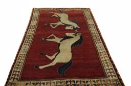 Surface texture of 2000s Persian Gabbeh rug with natural Wool and intricate pattern