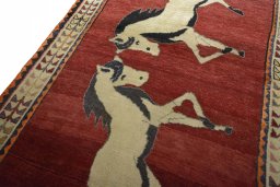 Backside of handmade 2000s Persian Gabbeh rug showing knot structure and weave density