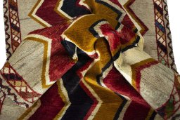 Corner detail of 2000s Persian Gabbeh rug showing border pattern and Wool pile