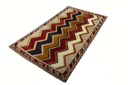 Corner detail of 2000s Persian Gabbeh rug showing border pattern and Wool pile