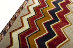 Backside of handmade 2000s Persian Gabbeh rug showing knot structure and weave density