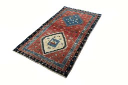 Corner detail of 2000s Persian Gabbeh rug showing border pattern and Wool pile