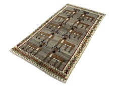 Corner detail of 2000s Persian Gabbeh rug showing border pattern and Wool pile
