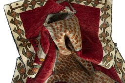 Corner detail of 2000s Persian Gabbeh rug showing border pattern and Wool pile