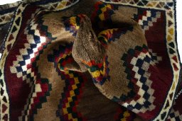 Corner detail of 2000s Persian Gabbeh rug showing border pattern and Wool pile