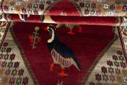 Corner detail of 2000s Persian Gabbeh rug showing border pattern and Wool pile