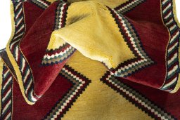 Corner detail of 2000s Persian Gabbeh rug showing border pattern and Wool pile