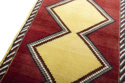 Backside of handmade 2000s Persian Gabbeh rug showing knot structure and weave density