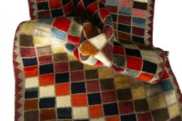 Corner detail of 2000s Persian Gabbeh rug showing border pattern and Wool pile