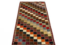 Surface texture of 2000s Persian Gabbeh rug with natural Wool and intricate pattern