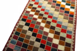 Backside of handmade 2000s Persian Gabbeh rug showing knot structure and weave density