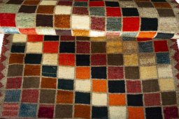 Full view of 2000s Persian Gabbeh rug from Iran / Persia, 141 × 80 cm in Multi Color tones