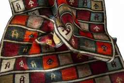 Corner detail of 2000s Persian Gabbeh rug showing border pattern and Wool pile