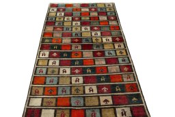 Surface texture of 2000s Persian Gabbeh rug with natural Wool and intricate pattern