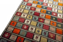 Backside of handmade 2000s Persian Gabbeh rug showing knot structure and weave density