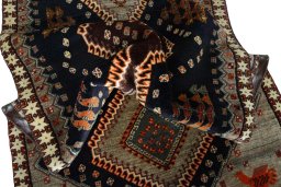 Corner detail of 2000s Persian Gabbeh rug showing border pattern and Wool pile