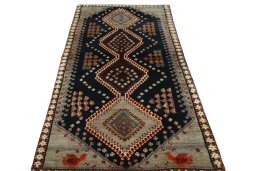 Surface texture of 2000s Persian Gabbeh rug with natural Wool and intricate pattern