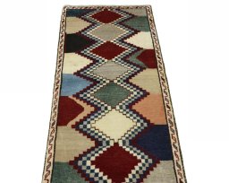 Surface texture of 2000s Persian Gabbeh rug with natural Wool and intricate pattern