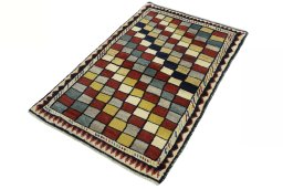 Corner detail of 2000s Persian Gabbeh rug showing border pattern and Wool pile